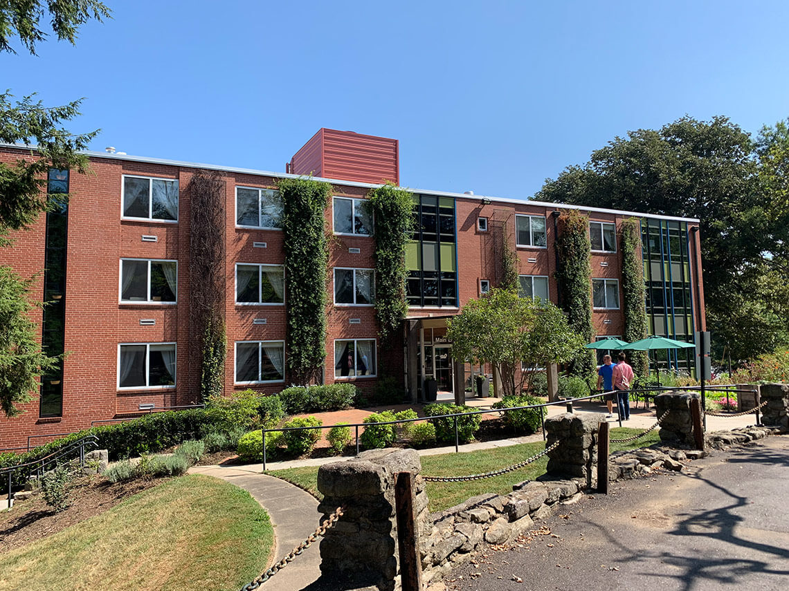 a large brick building houses the Asheville mental health recovery center CooperRiis